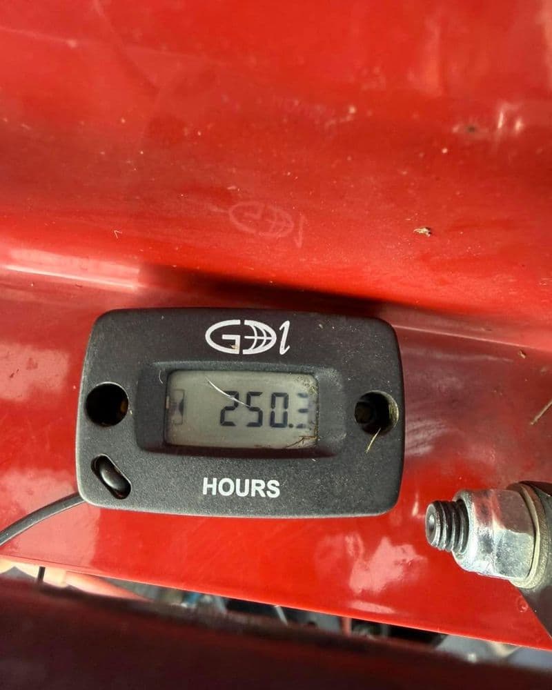 Digital hour meter displaying 250.3 hours on red machinery panel. Accurate equipment usage tracking.