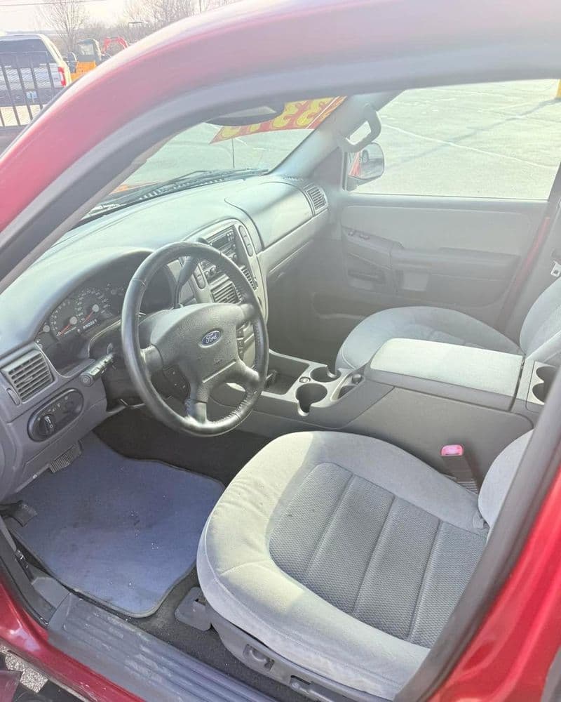 Interior view of a red Ford vehicle showing dashboard and seating details.