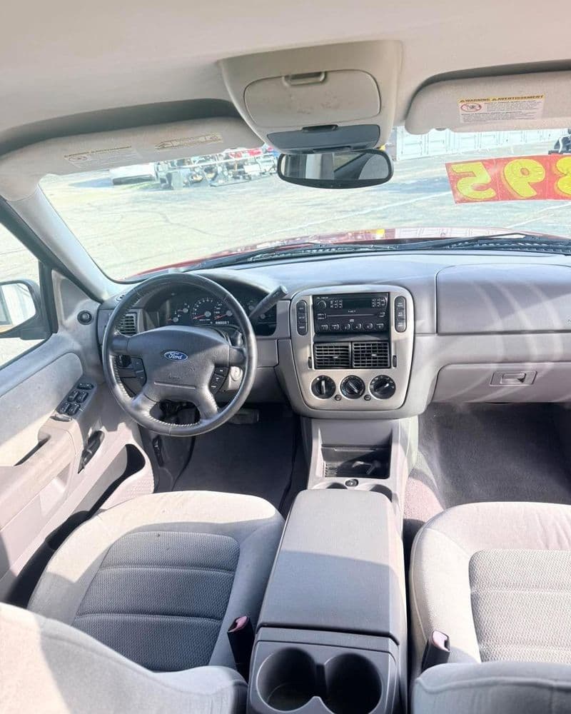 Interior view of a Ford vehicle, featuring dashboard, control panel, and seating details.