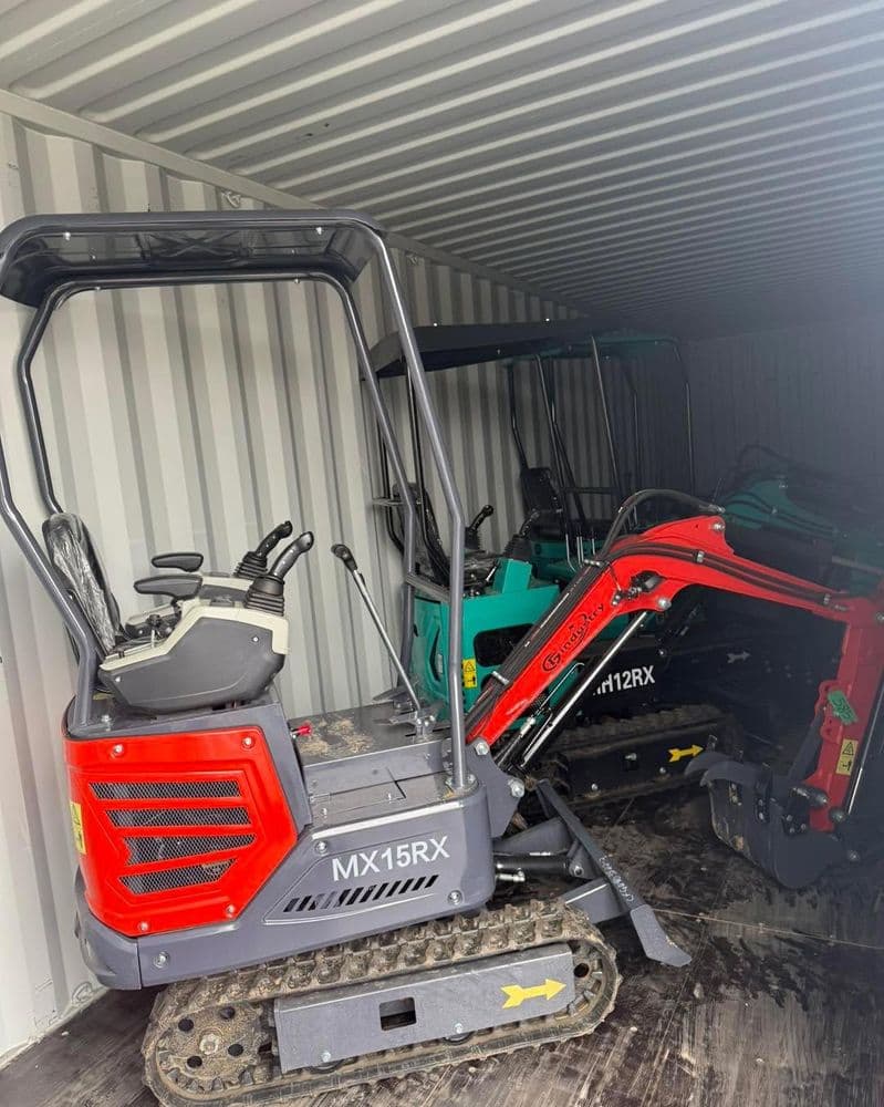 Compact construction machinery in shipping container, featuring MX15RX and other models.