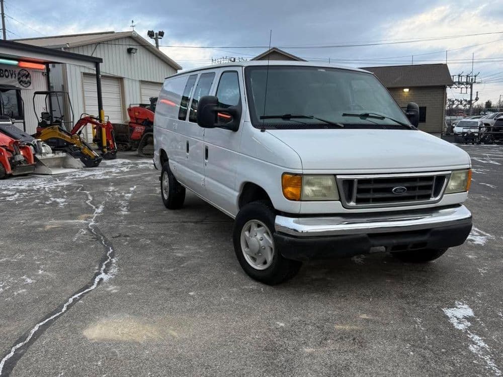 White Ford van parked outside, showcasing a versatile vehicle suitable for transportation needs.
