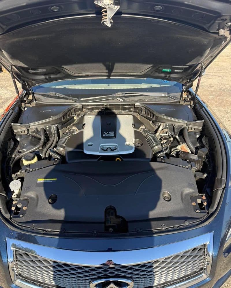 V8 engine showcased in a luxury car with hood open, highlighting performance features.