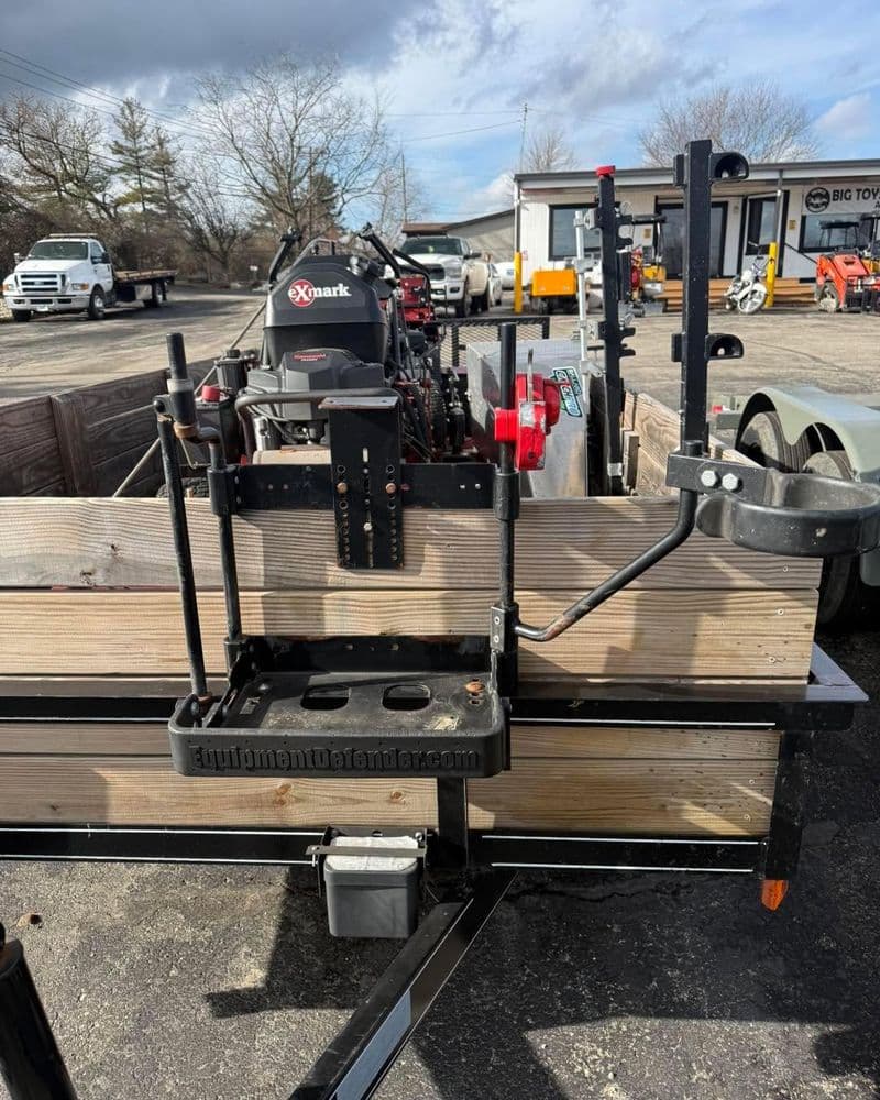 Lawn care trailer with an Exmark engine and equipment ready for landscaping services.