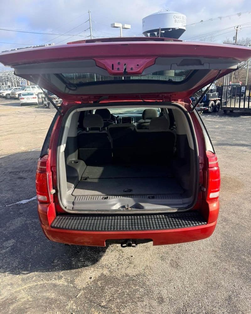 Red SUV with open rear hatch, showcasing empty cargo space and interior seating.