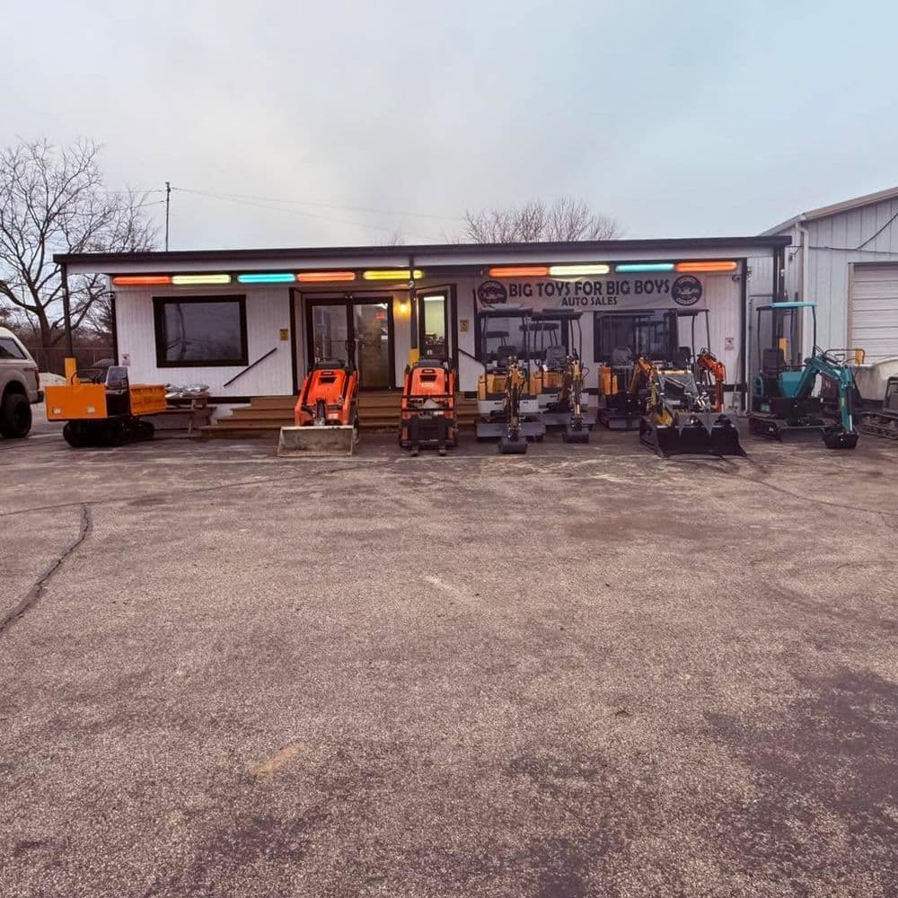 Storefront of Big Toys for Big Boys with assorted construction equipment on display.