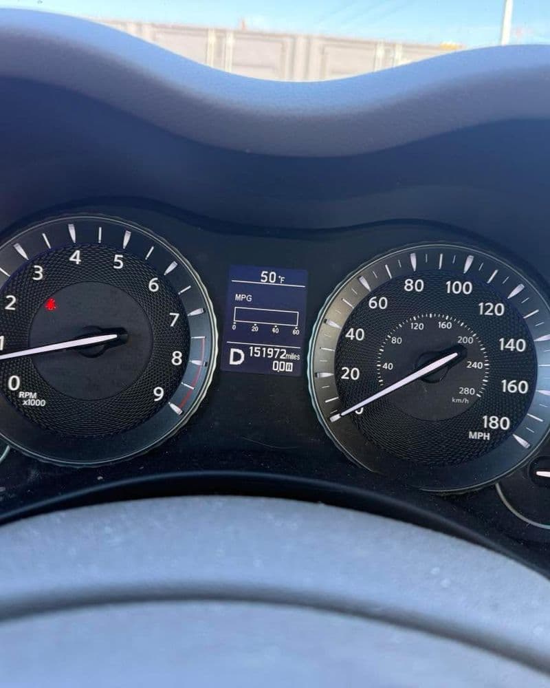 Dashboard view of a car showing speed, fuel economy, and odometer reading.