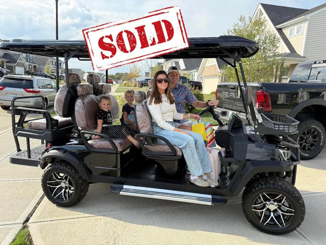 Family enjoying a sold golf cart in a suburban neighborhood with children and bags.
