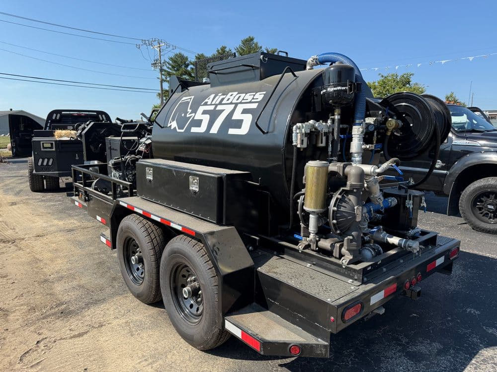 AirBoss 575 pressure washer trailer with industrial equipment on a black vehicle.