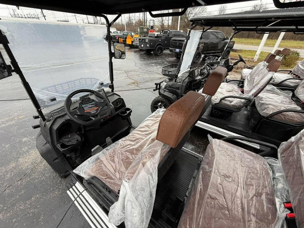 New utility vehicle interior with protective covers on seats, showcasing dashboard and controls.